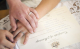 Hands on wedding certificate
