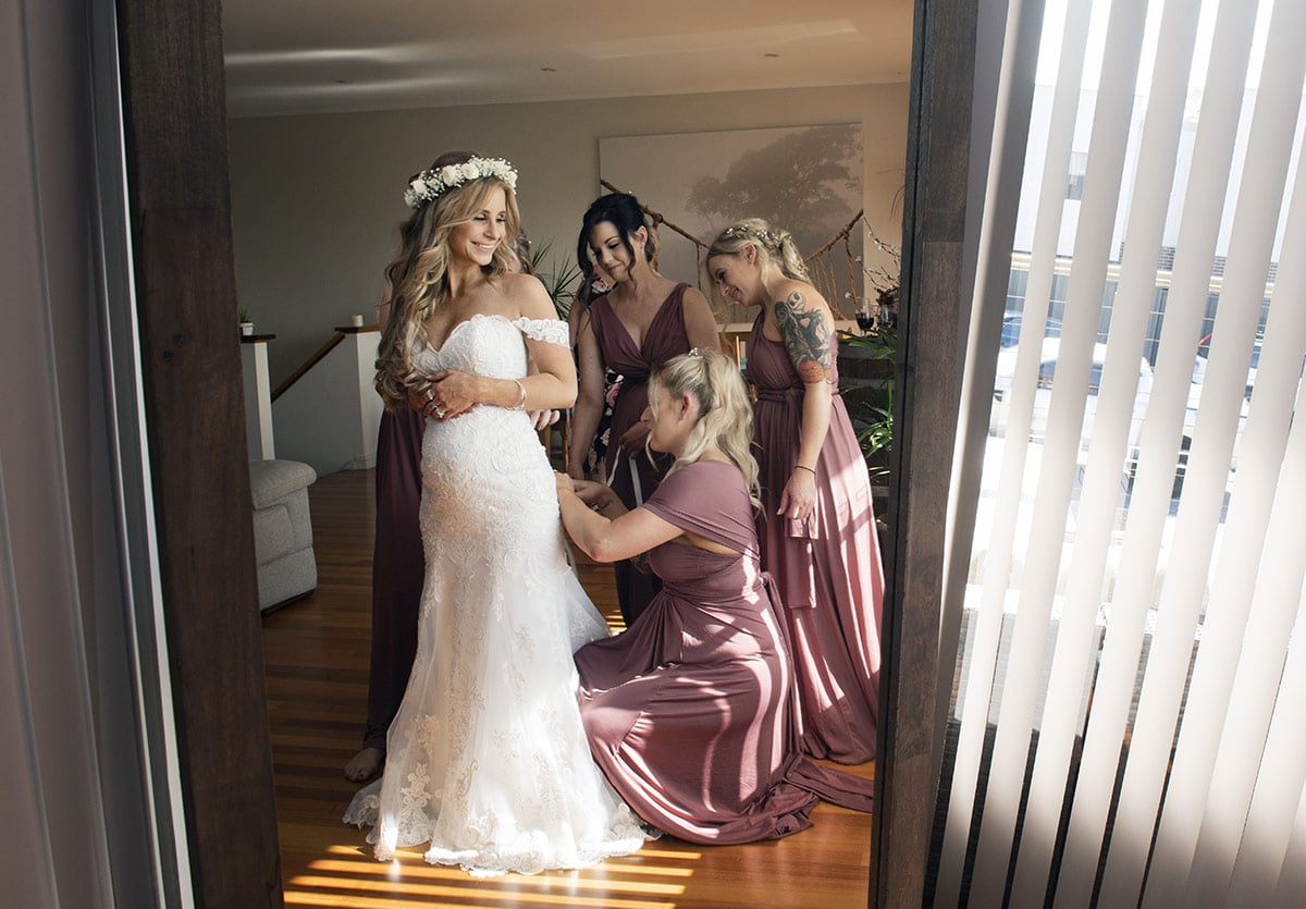 pepper tree cafe wedding - amanda & daniel 88 Helping with the dress