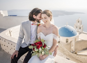 beautiful santorini wedding - greece - kerri & tony 13 Bride and groom in front of blue domed church