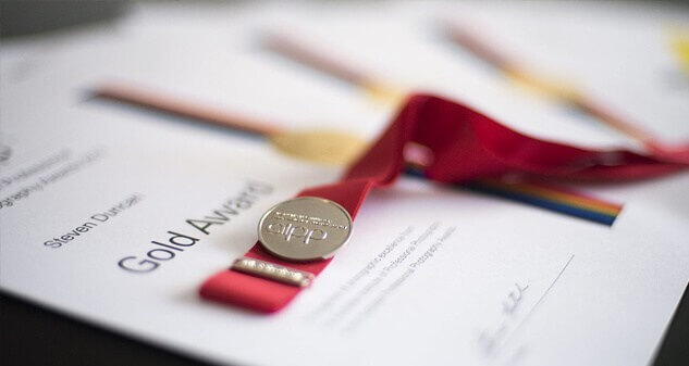 5 tips to help you find the right wedding photographer 2 Gold award certificate with a medal and red ribbon