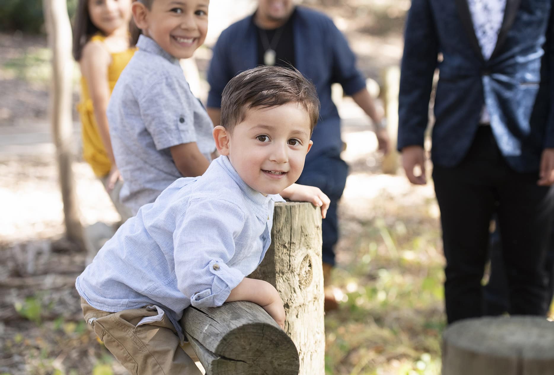 Little boy climbing fence