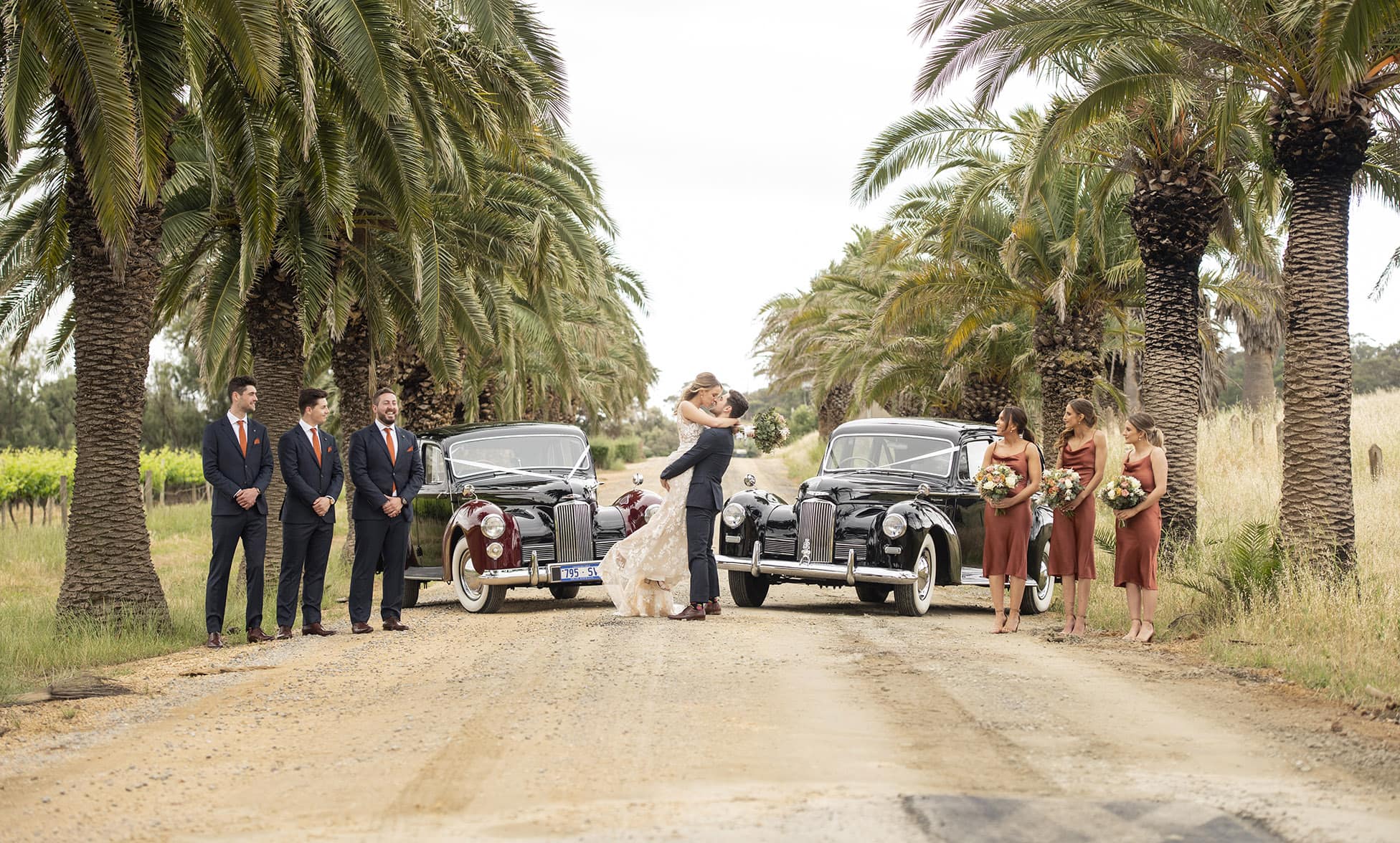 seppeltsfield winery wedding - tahlia & alex 60 bridal party in front of bridal cars on Seppeltsfield rd
