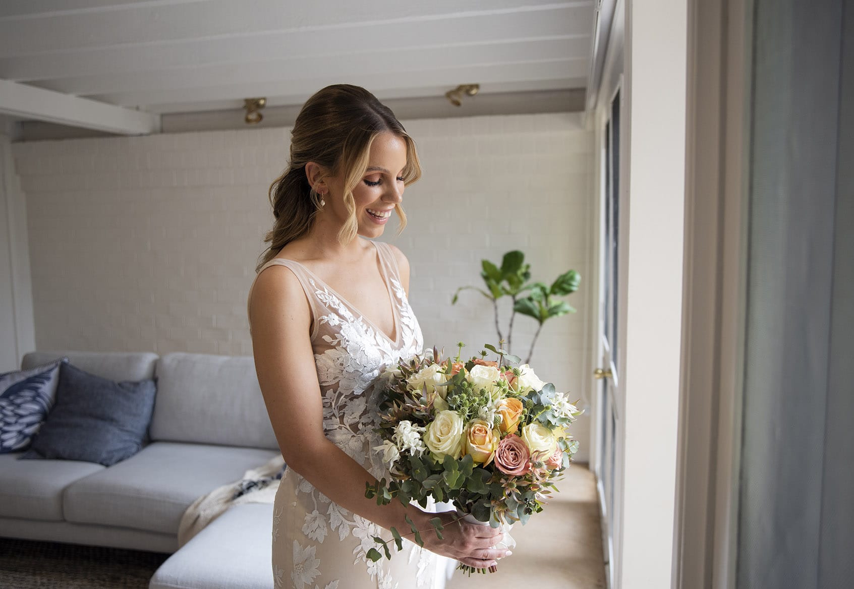 seppeltsfield winery wedding - tahlia & alex 25 Bride playing with her bouquet in front of window