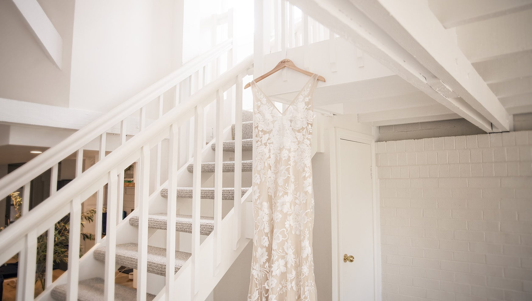 seppeltsfield winery wedding - tahlia & alex 13 Wedding dress hanging on white stairs