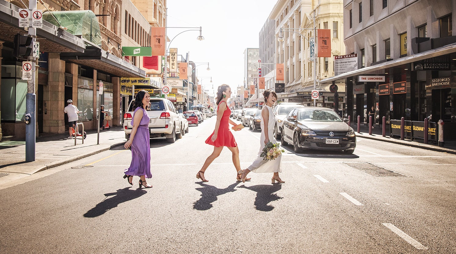 5 tips to help you find the right wedding photographer 1 bridal party walking accross Hindley st