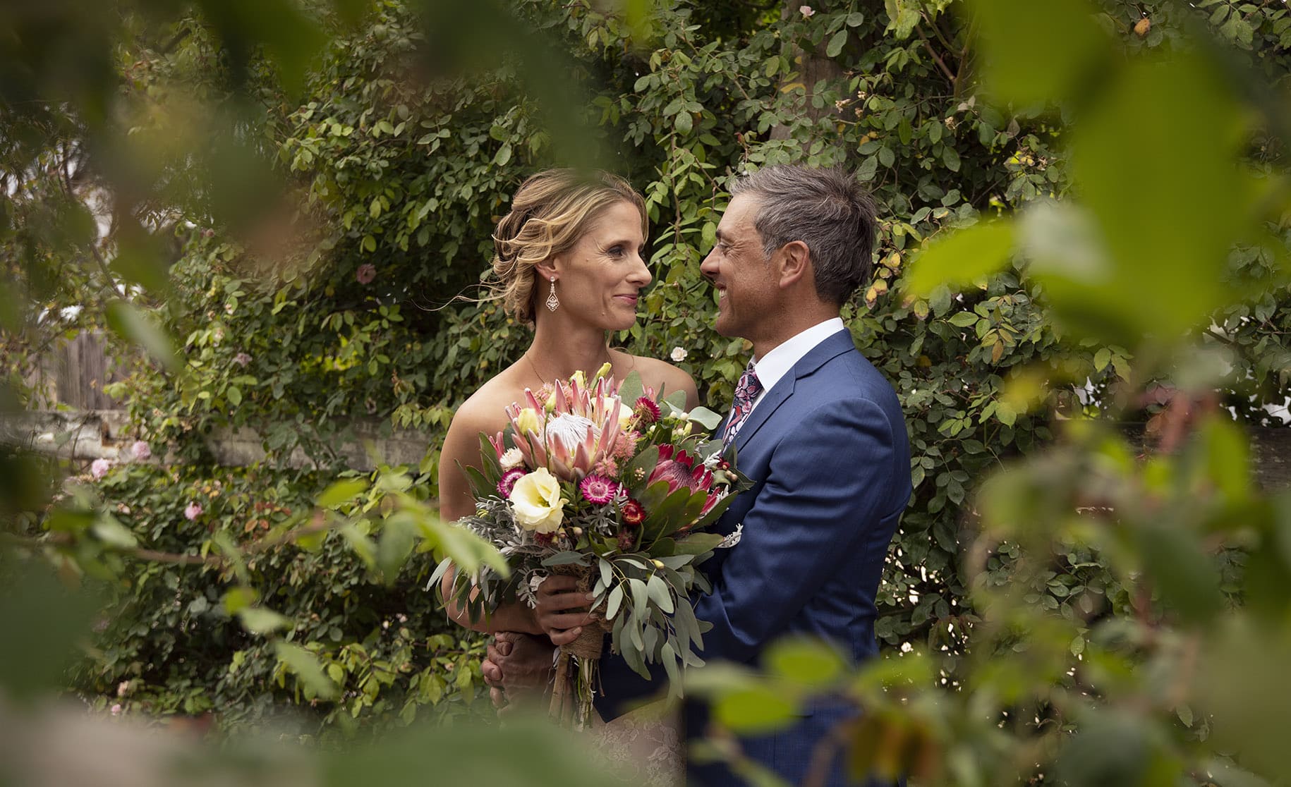 crabtree farm wedding - sarah & elten 26 bridal couple through the foliage at Crabtree farm