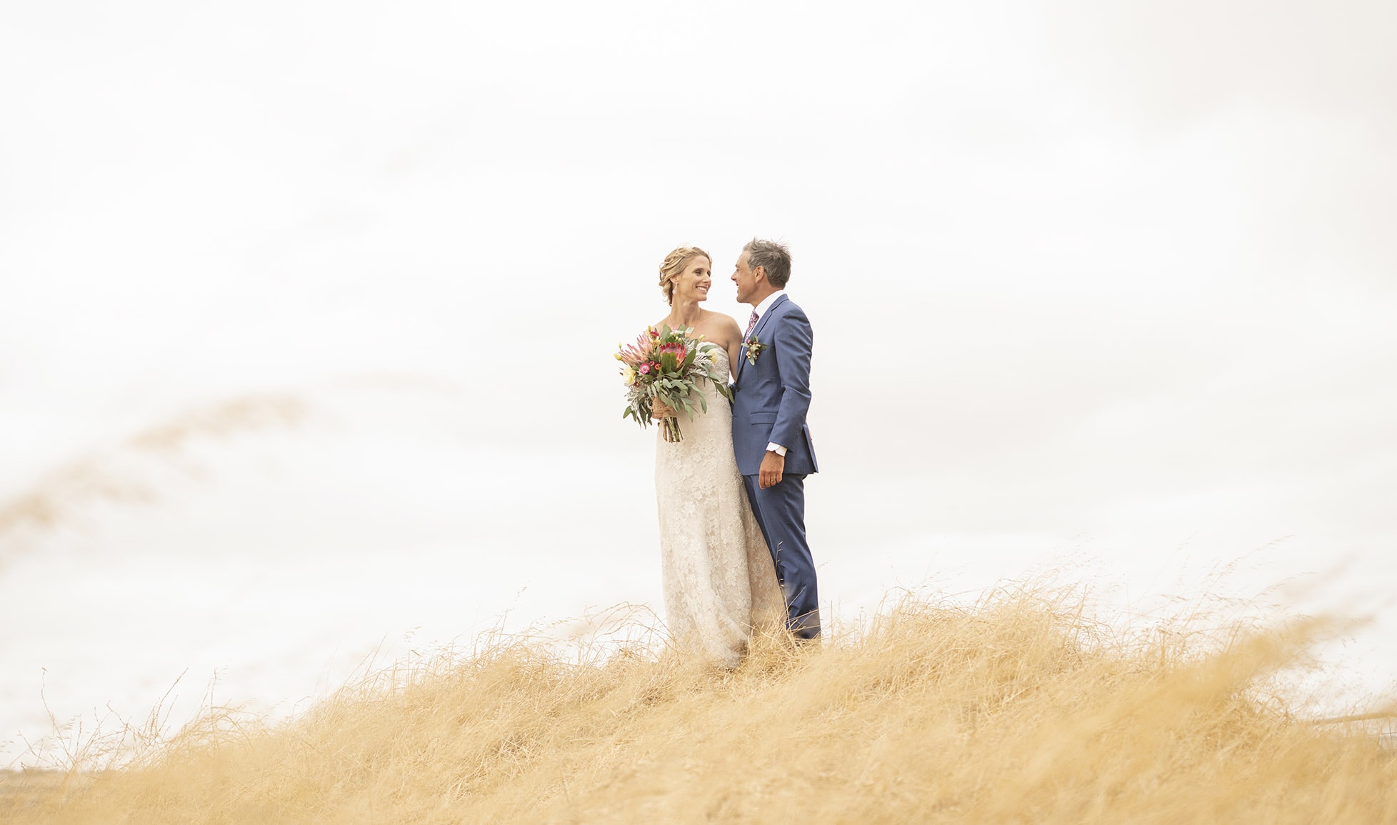 crabtree farm wedding - sarah & elten 32 bride and groom on the top of a grassy hill