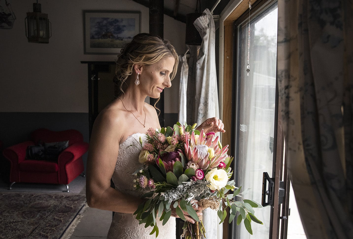 crabtree farm wedding - sarah & elten 5 bride looking at her bouquet