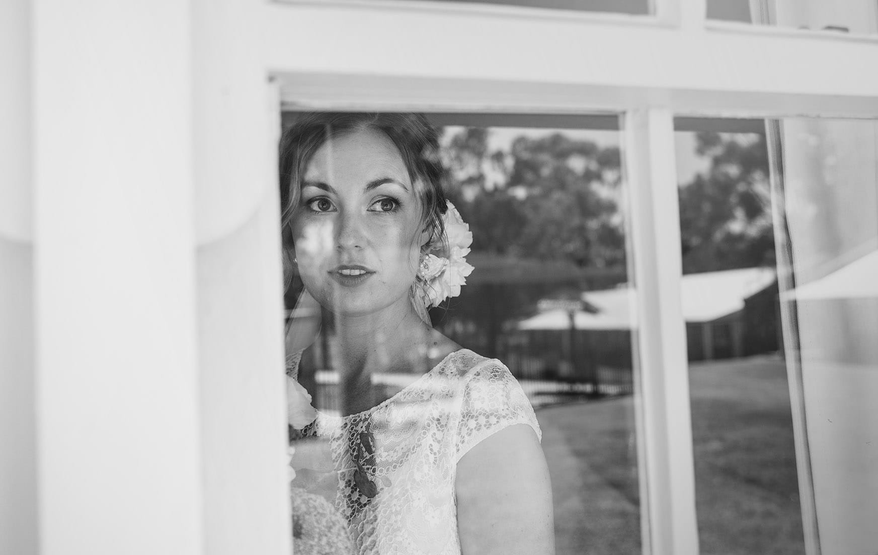 serafino wines wedding - claire & arron 33 Bride through the window