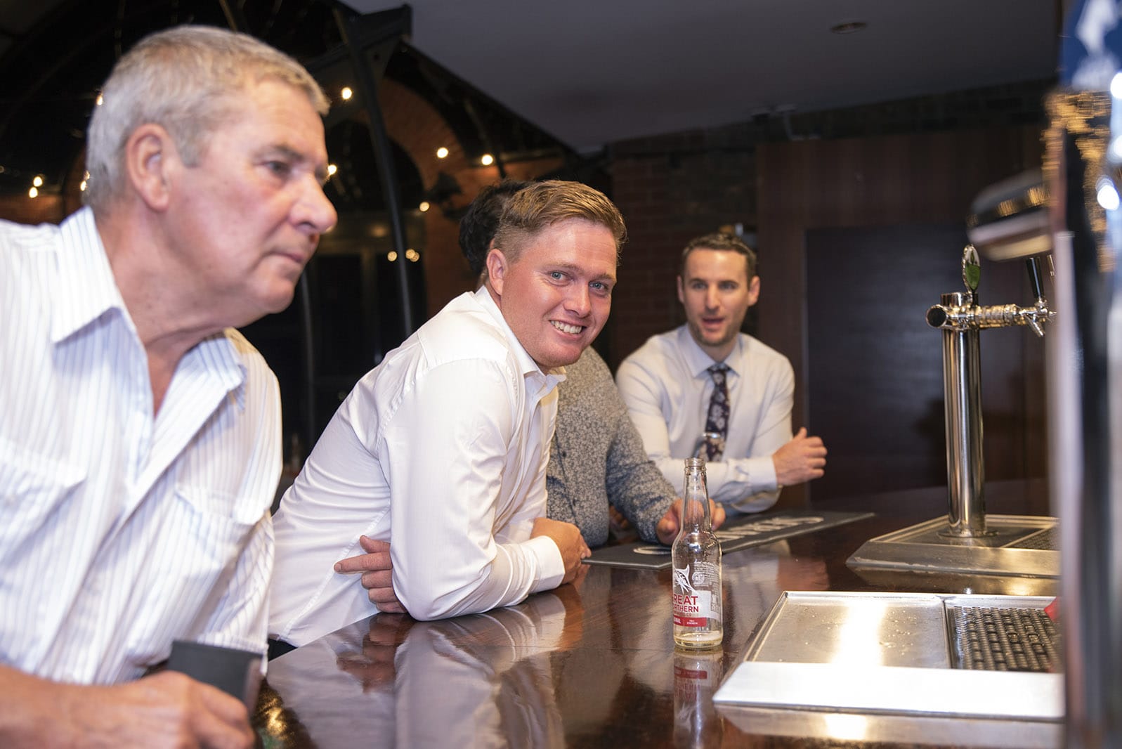 serafino wines wedding - claire & arron 77 Guests leaning on the bar