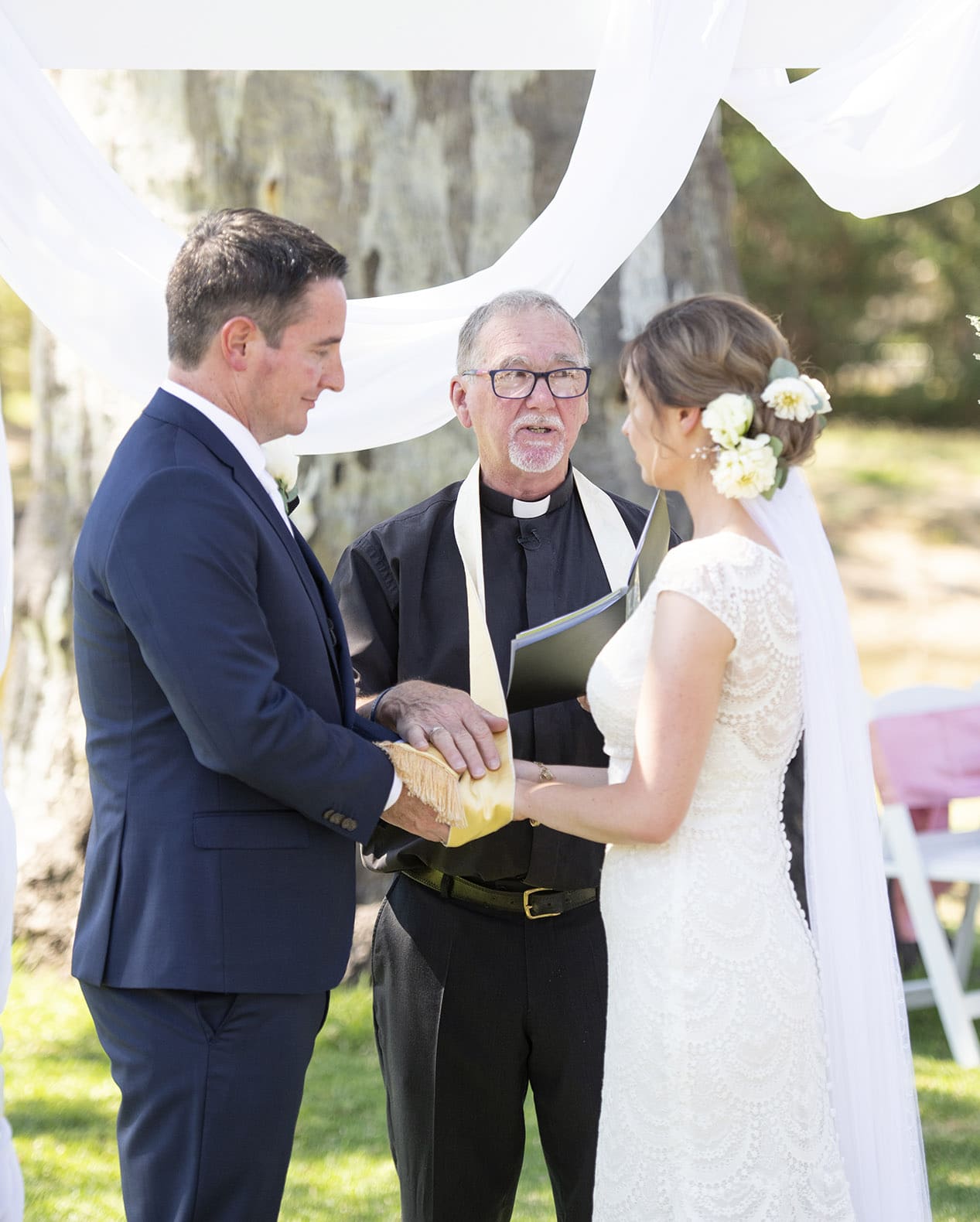 serafino wines wedding - claire & arron 46 Priest blessing the couple during their wedding ceremony