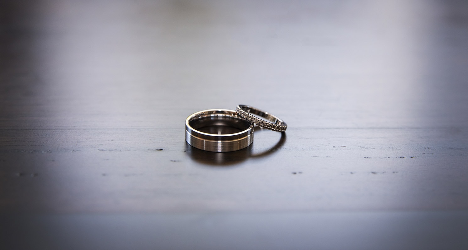 serafino wines wedding - claire & arron 8 Wedding rings on table top