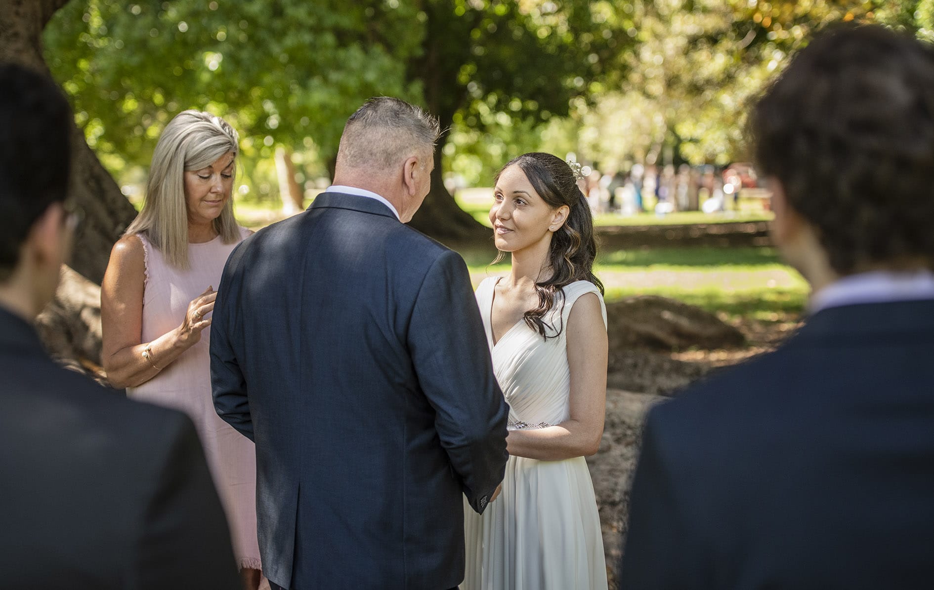 botanic park wedding - naz & peter 15 Shot of bride though shoulders of Sons