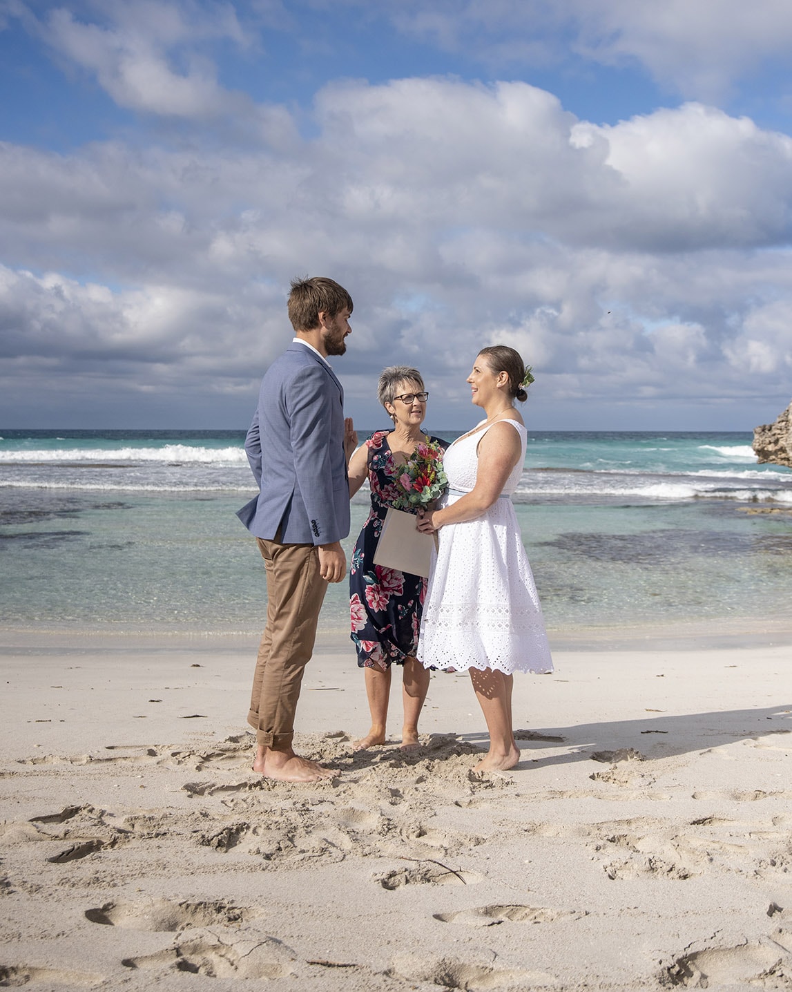 kangaroo island elopement - claire & jacob 24 Claire and Jacob standing with their celebrant during their beach elopement ceremony at Pennington Bay