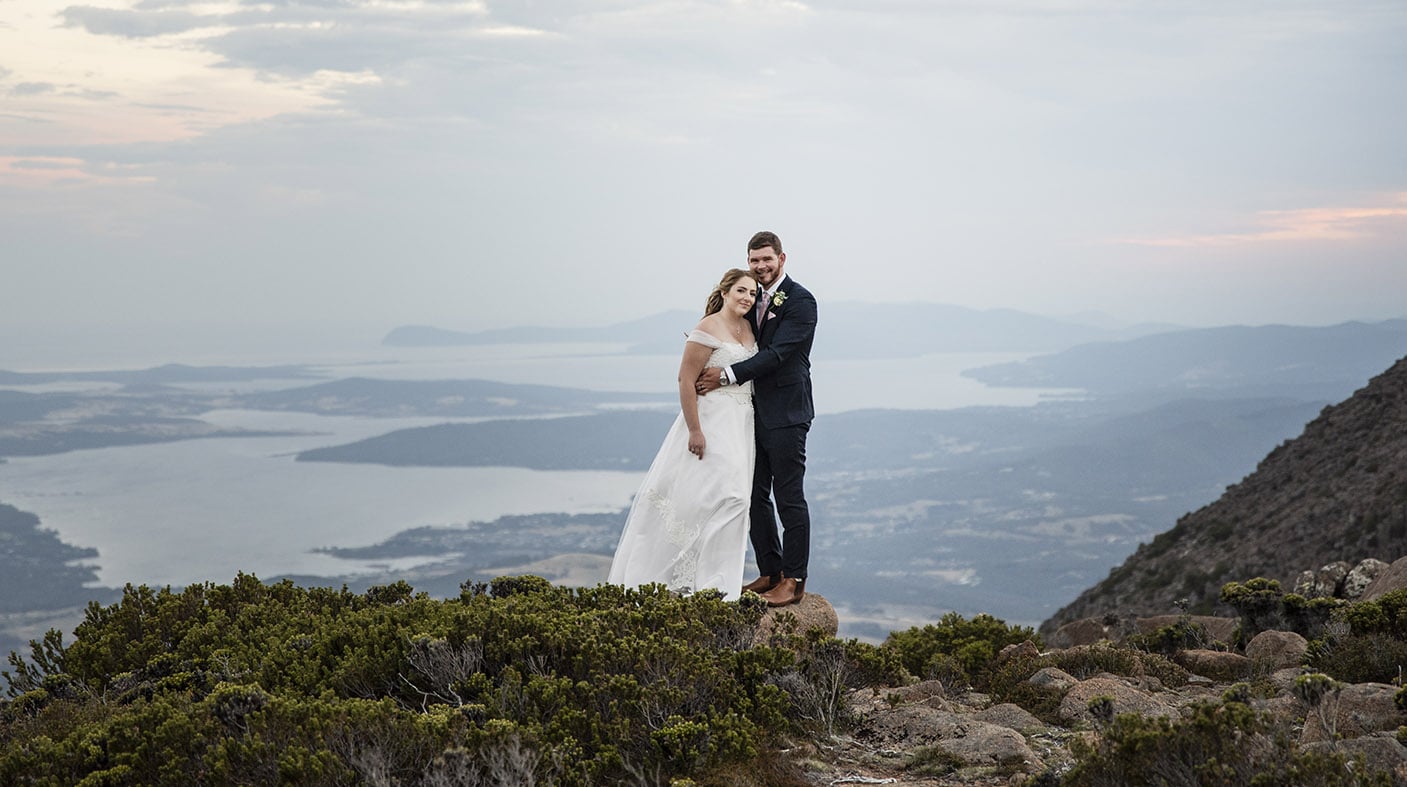 seagrass long point wedding - hobart - georgia & matt 26 Bride and groom on a mountain