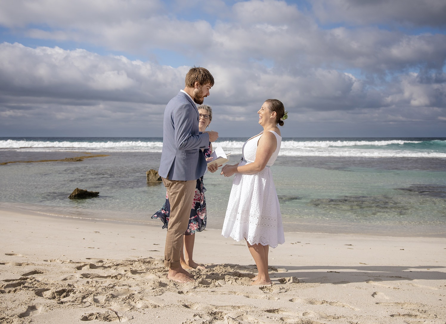 kangaroo island elopement - claire & jacob 27 Claire and Jacob holding hands during their beach elopement ceremony beside the ocean on Kangaroo Island
