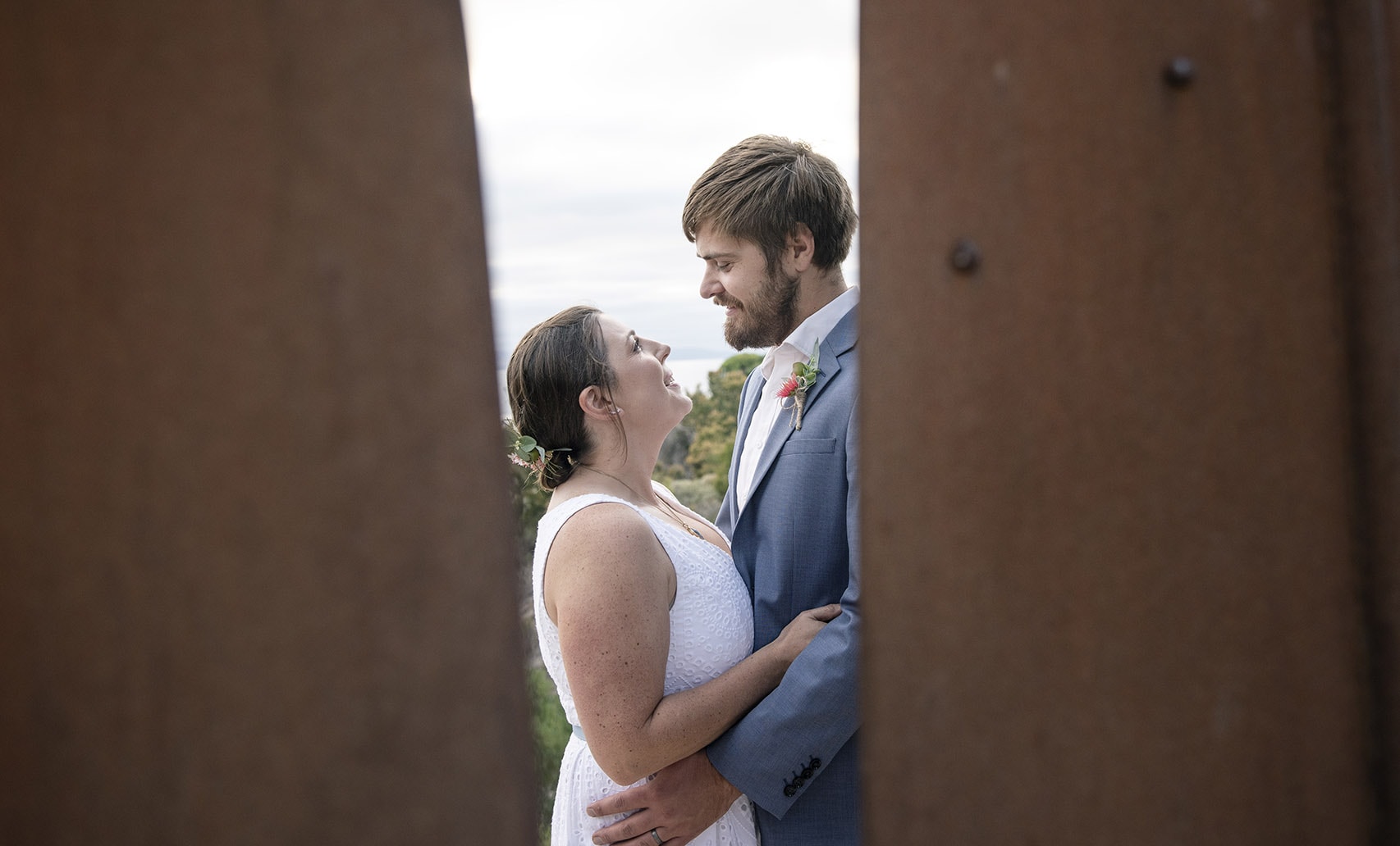 kangaroo island elopement - claire & jacob 11 Claire and Jacob smiling at one another between two rusted steel sculpture panels during their Kangaroo Island elopement