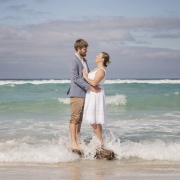 natural kangaroo island wedding photography 1 Claire and Jacob standing on a rock in the surf during their Kangaroo Island elopement photoshoot
