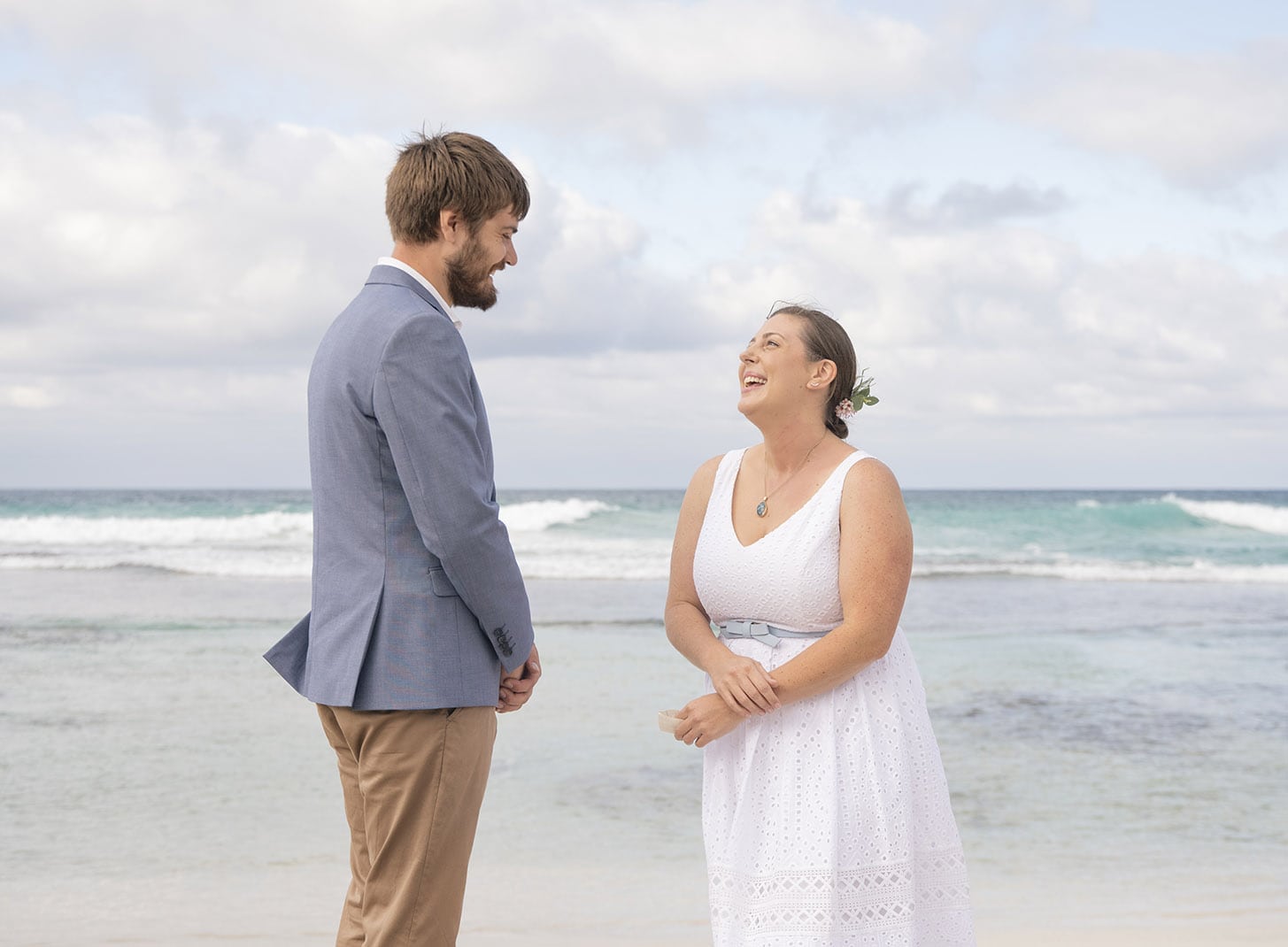 kangaroo island elopement - claire & jacob 30 Claire and Jacob laughing together on a Kangaroo Island beach, with waves behind them