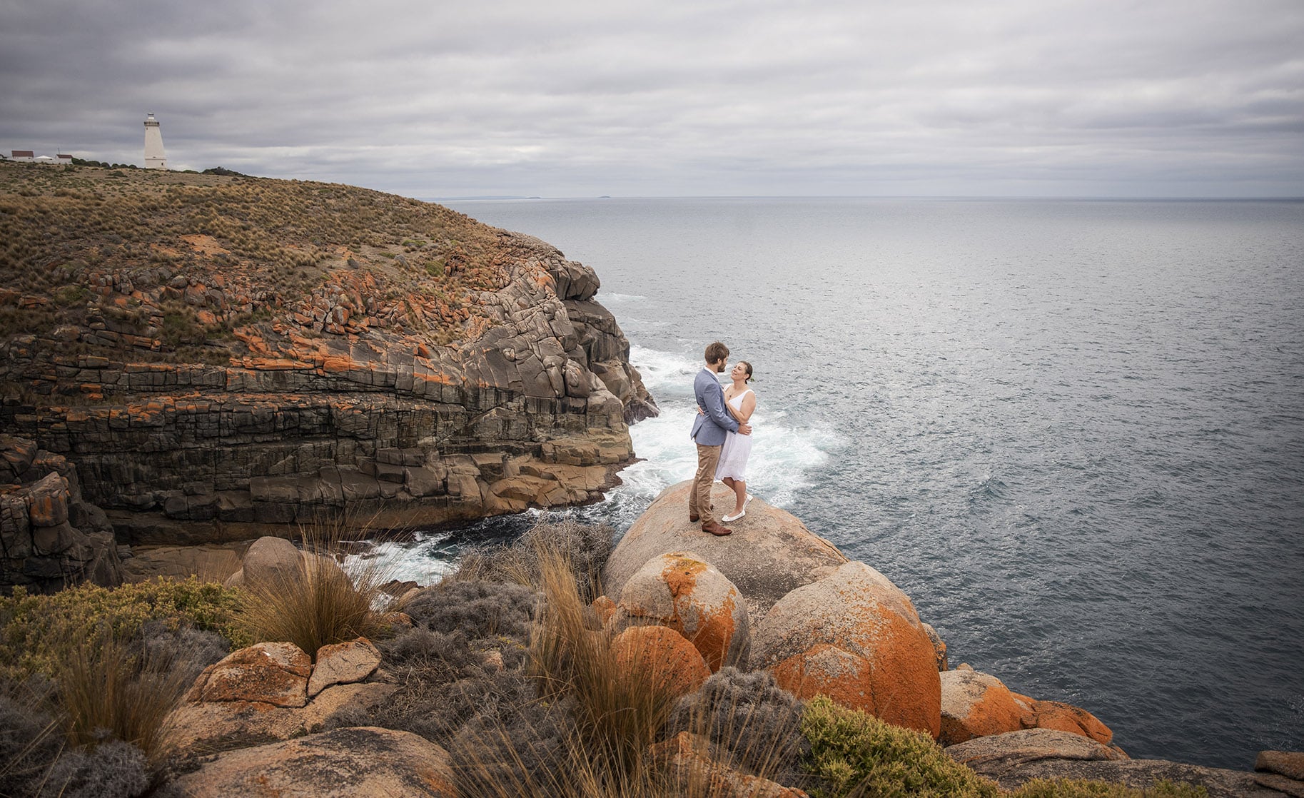 kangaroo island elopement - claire & jacob 19 Claire and Jacob standing together on coastal boulders beneath Cape Willoughby Lighthouse on Kangaroo Island