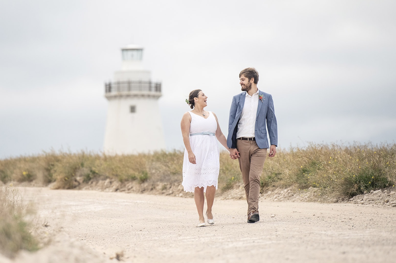 kangaroo island elopement - claire & jacob 23 Claire and Jacob holding hands on a path in front of Cape Willoughby Lighthouse, Kangaroo Island