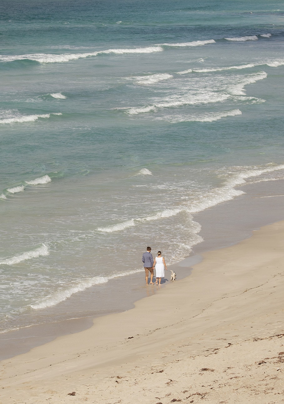 kangaroo island elopement - claire & jacob 37 Couple walking barefoot with their dog along the shoreline at Pennington Bay, Kangaroo Island