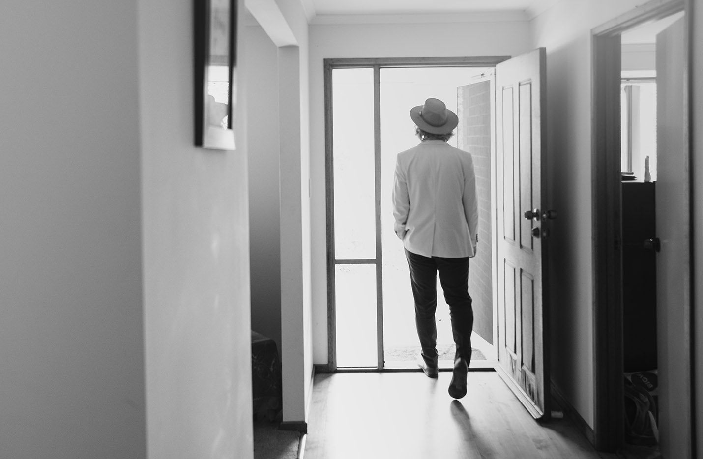 old oval estate wedding - suzie & jay 65 Groom walking out hallway door