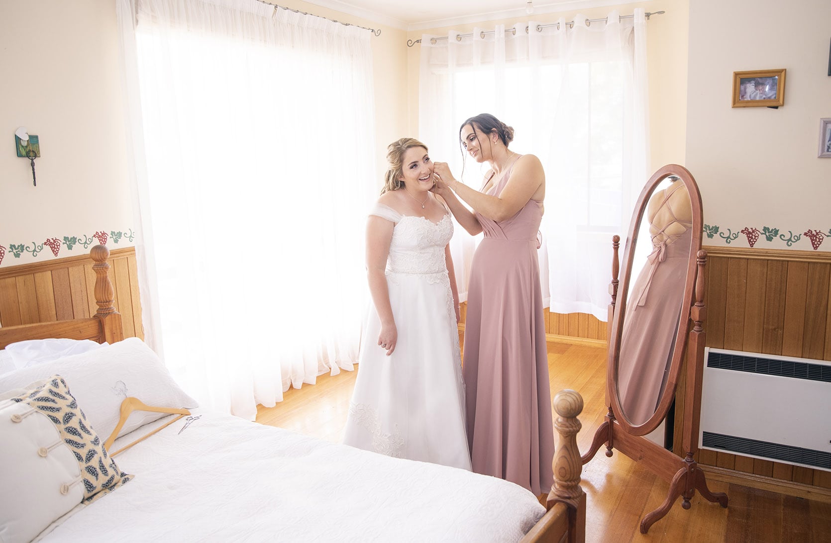 seagrass long point wedding - hobart - georgia & matt 50 Helping the bride put on her dress in a well lit room