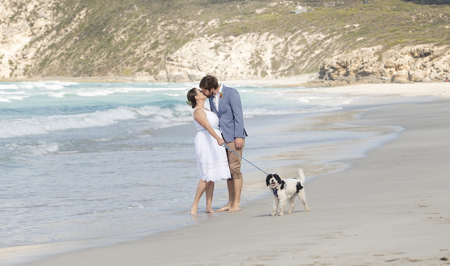 kangaroo island elopement - claire & jacob 38 Claire and Jacob kissing barefoot on a Kangaroo Island beach beside their black and white dog