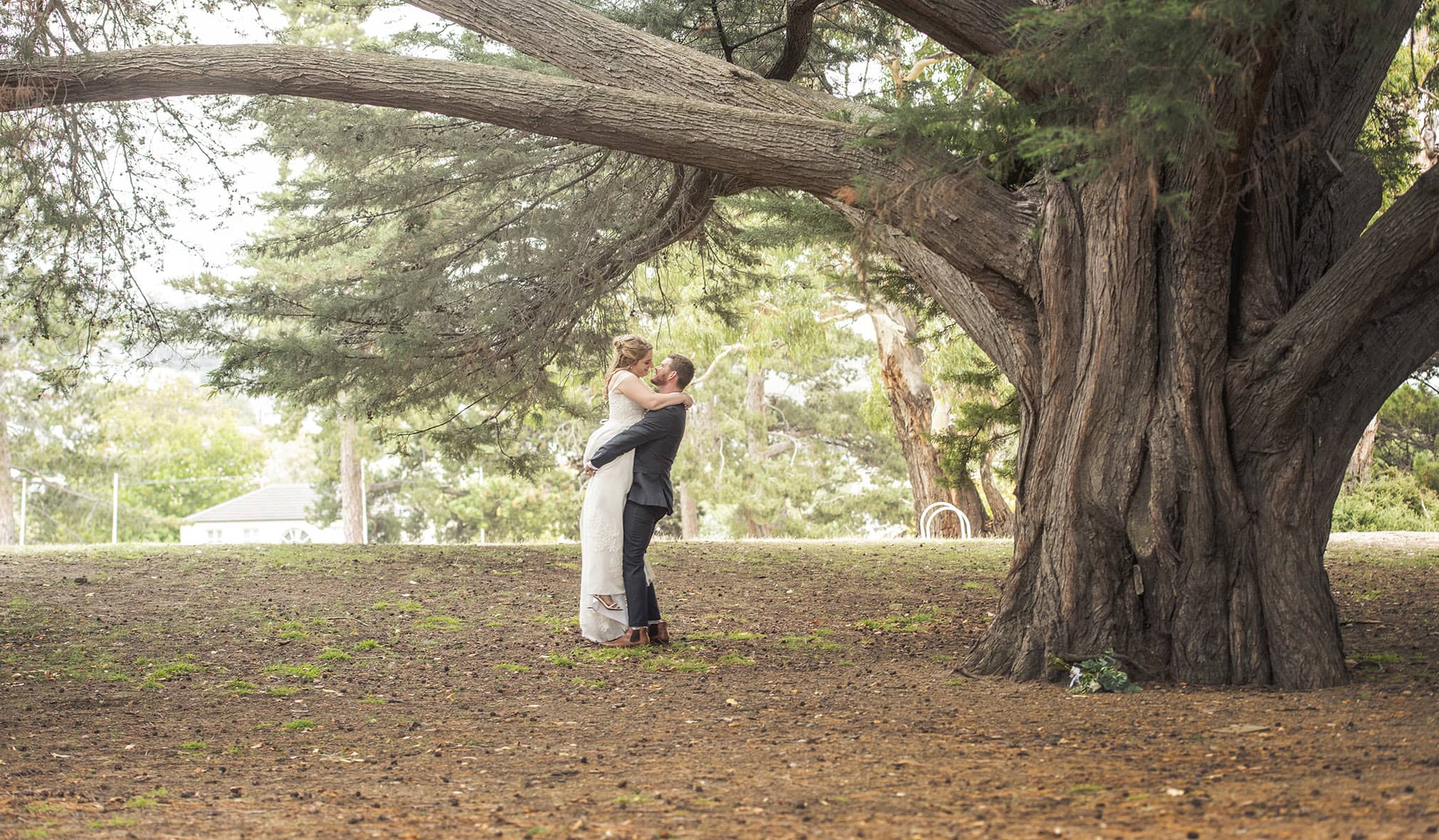 seagrass long point wedding - hobart - georgia & matt 69 Lifting up the bride under a large tree