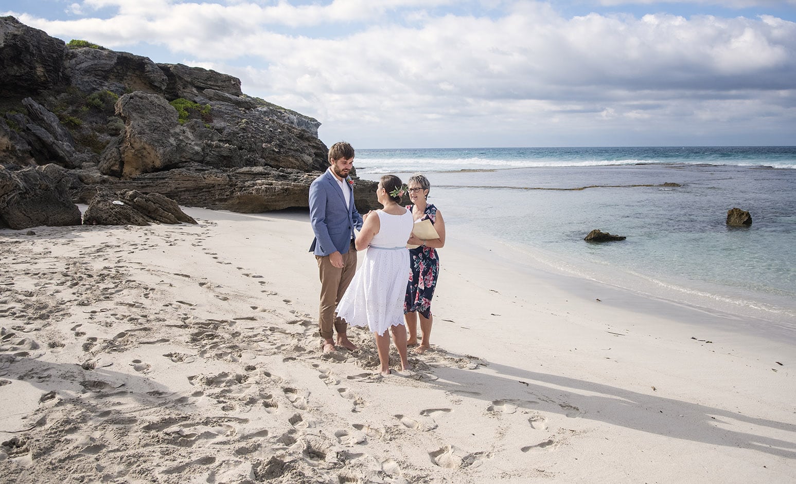 kangaroo island elopement - claire & jacob 28 Claire and Jacob standing with their celebrant on the sand during their Pennington Bay elopement ceremony
