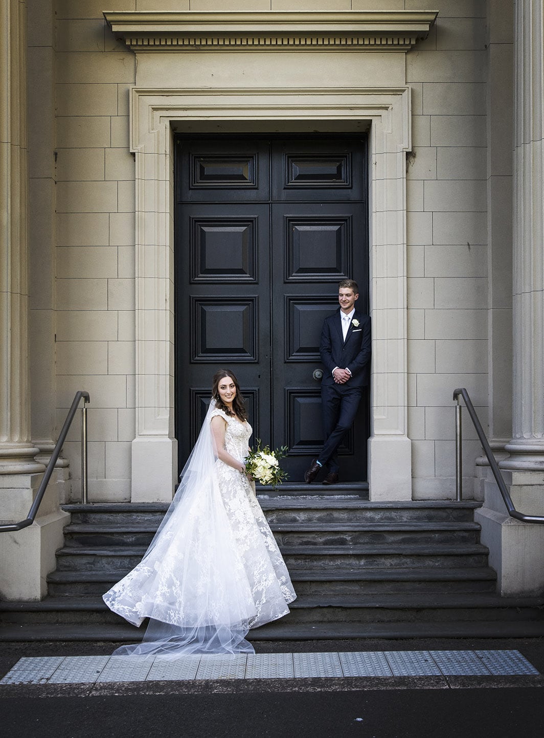 national wine center wedding - pat & kat 170 bride and groom in front of a doorway