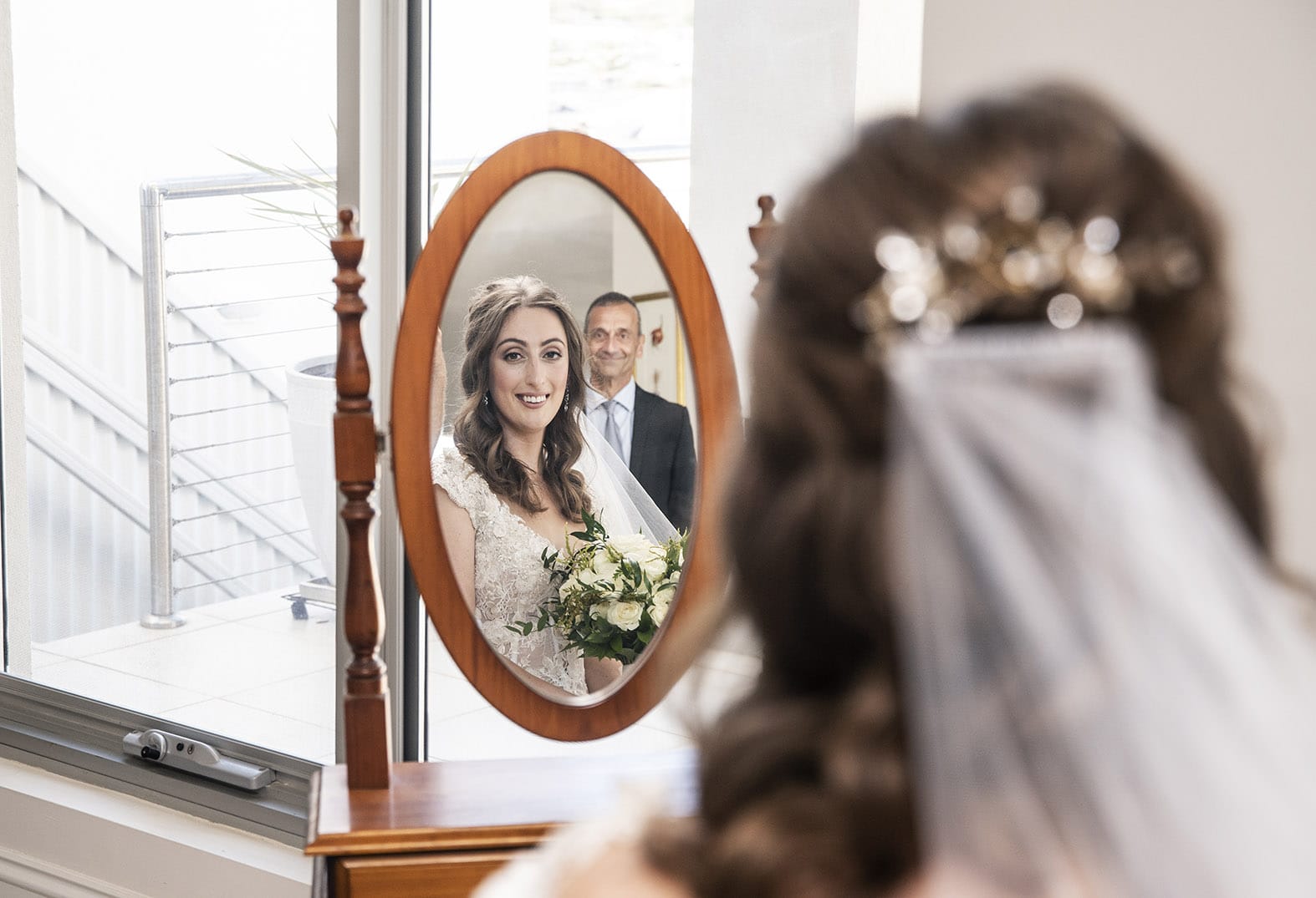 national wine center wedding - pat & kat 136 Bride looking in mirror as Dad looks on