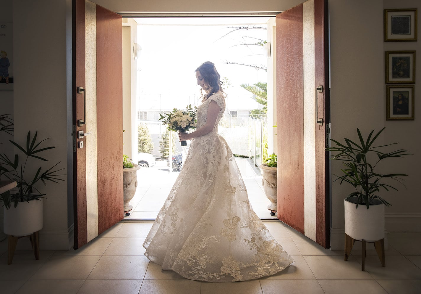 national wine center wedding - pat & kat 134 bride standing in front of front door in wedding gown