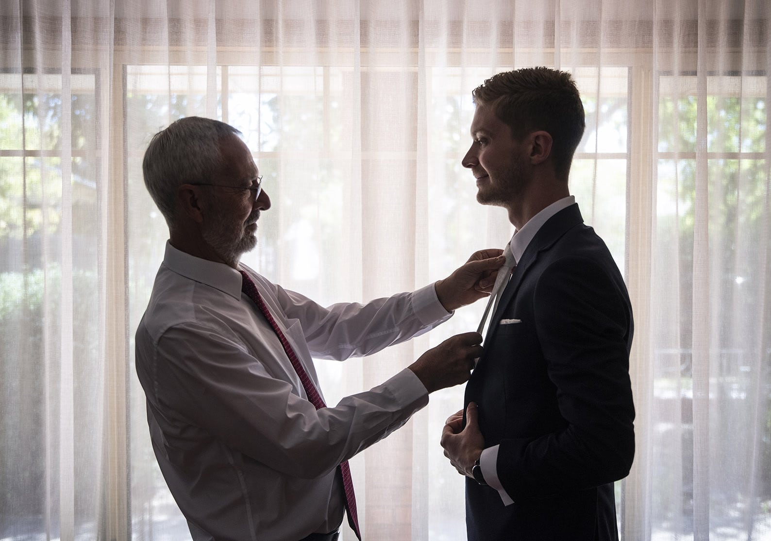 national wine center wedding - pat & kat 116 Dad helping son put on tie
