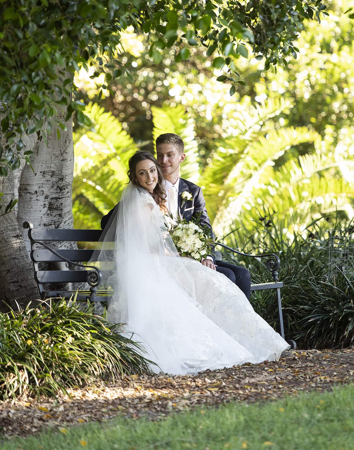 national wine center wedding - pat & kat 159 Sitting on a bench together under a tree