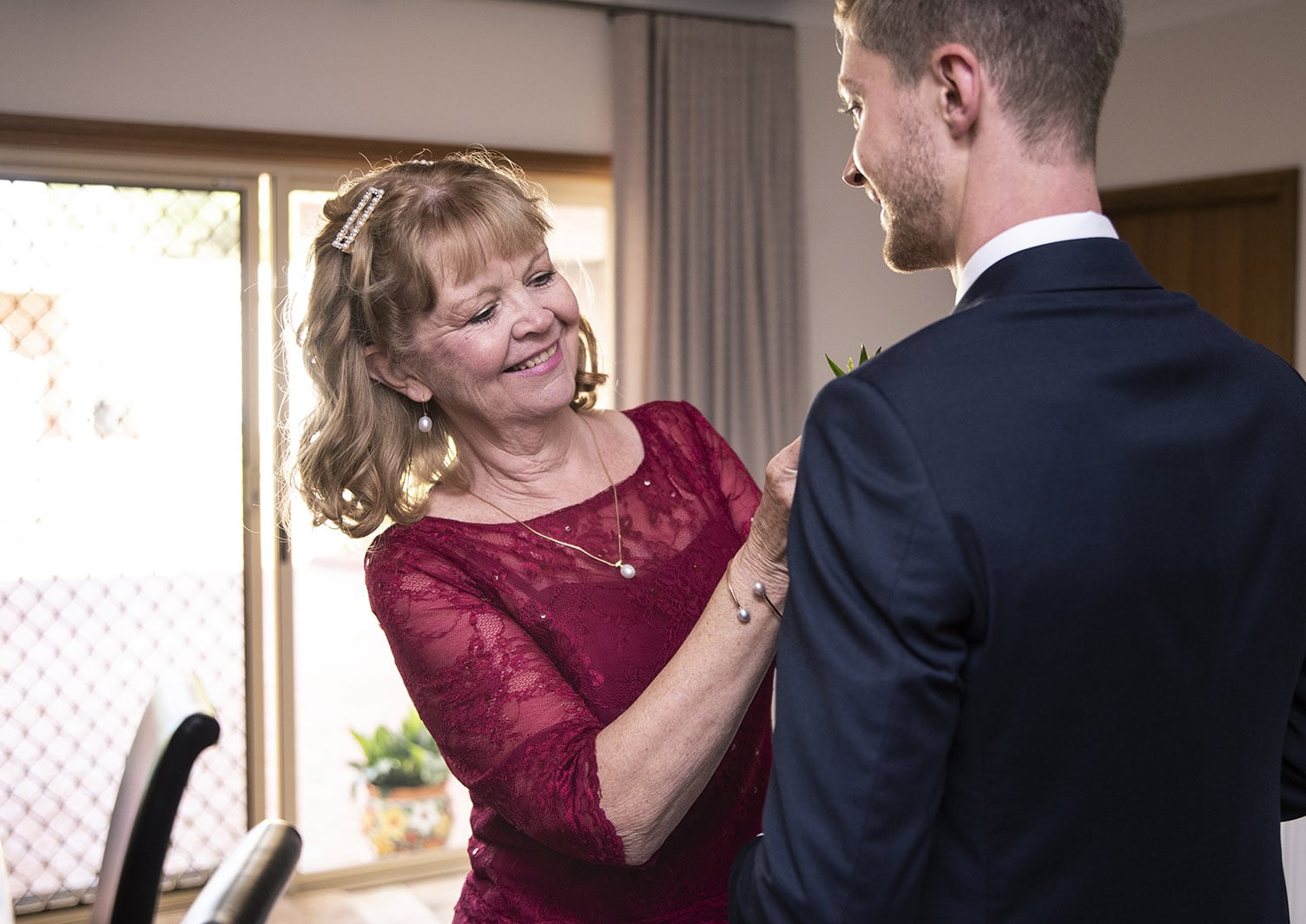 national wine center wedding - pat & kat 118 Smiling Mum as she helps with tie