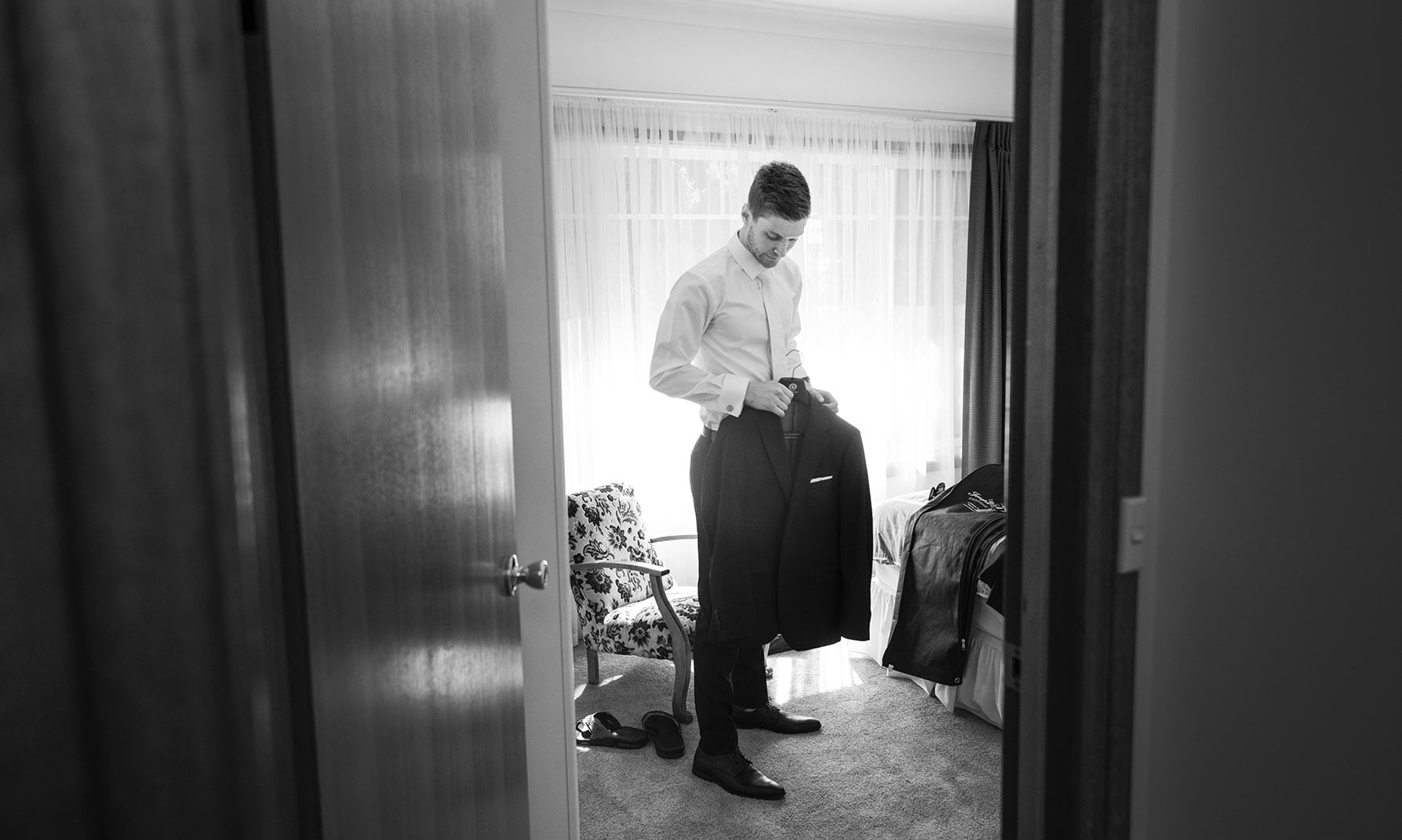 national wine center wedding - pat & kat 113 Through the doorway at groom getting ready