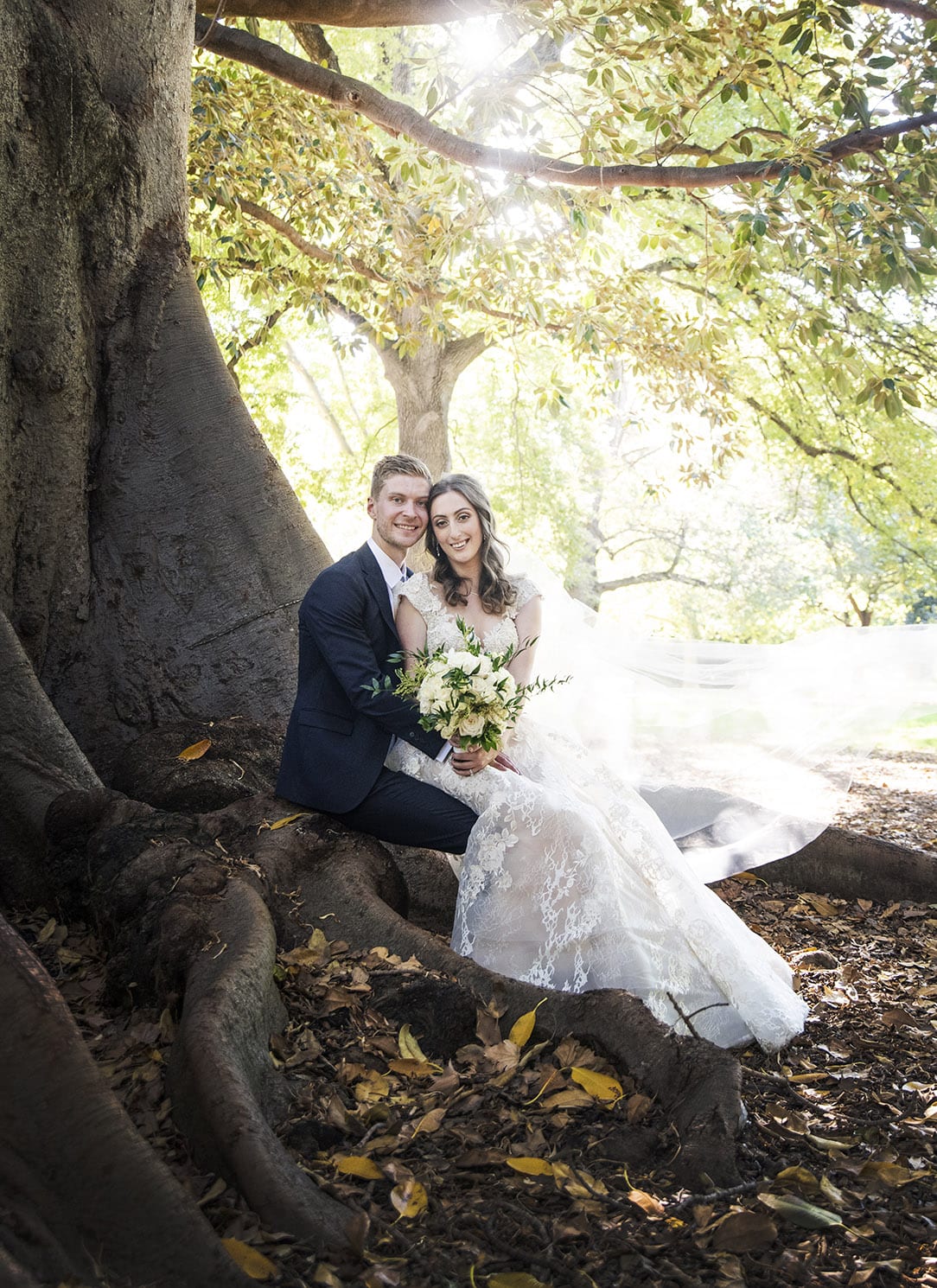 national wine center wedding - pat & kat 163 Together sitting on the roots of a large fig tree