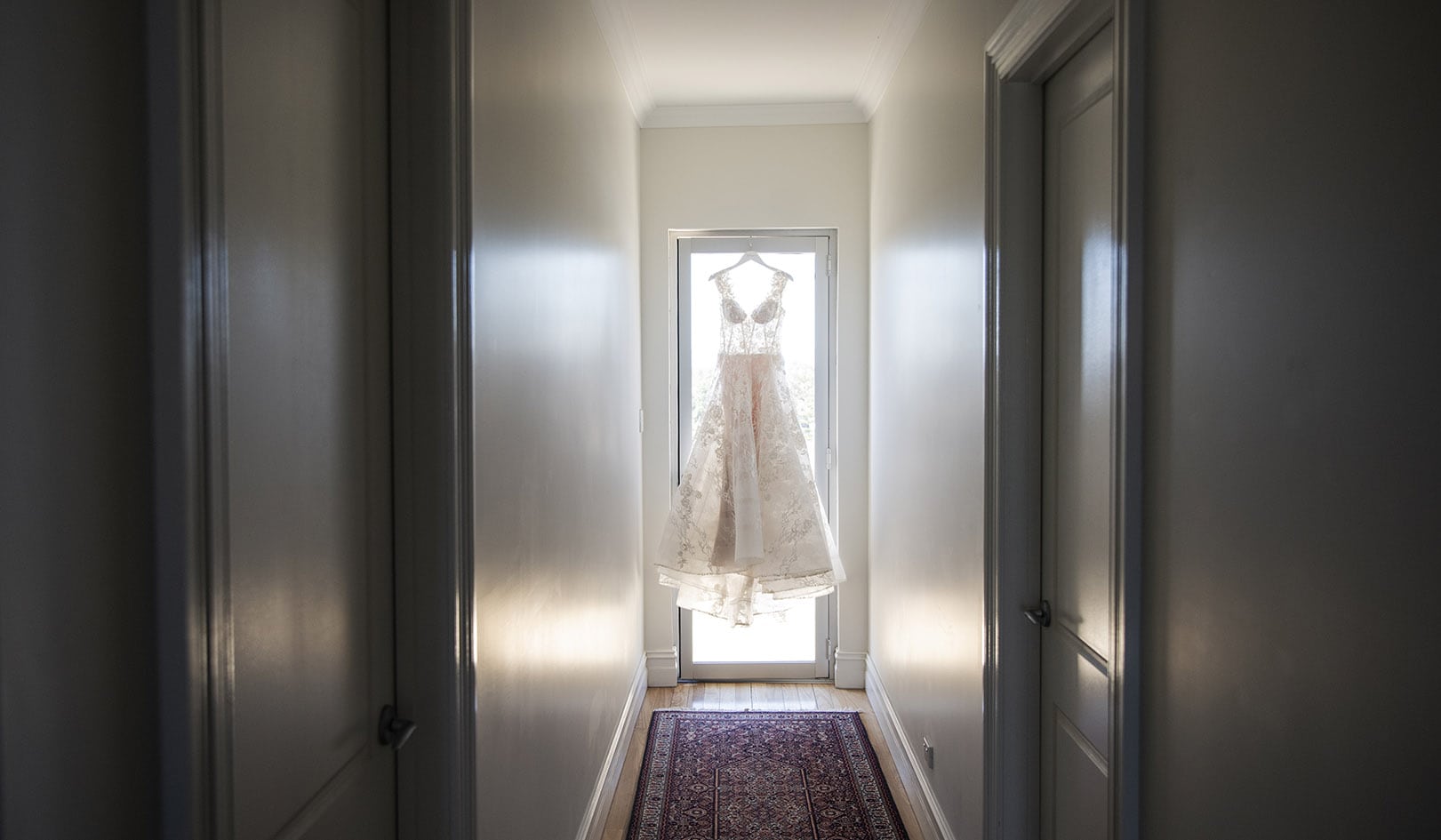 national wine center wedding - pat & kat 122 Wedding dress hanging at end of hall