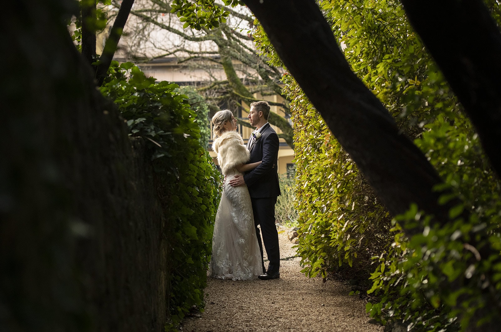 mount lofty house wedding - katrina & lucas 51 Embrace on the walkway through the gardens
