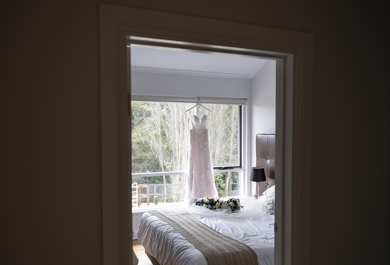 mount lofty house wedding - katrina & lucas 14 Wedding dress hanging through doorway