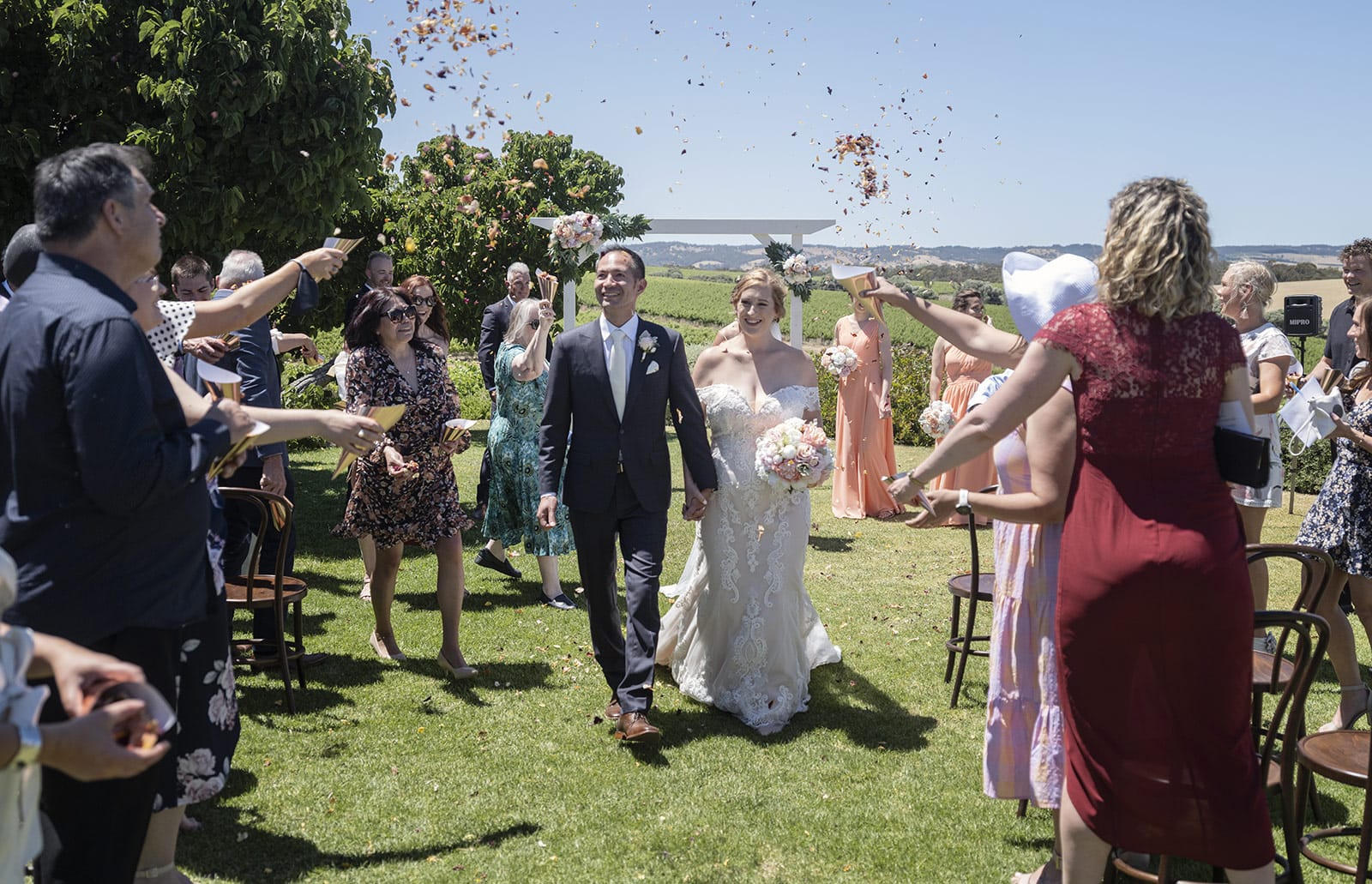 coriole wines wedding - marielle & brendan 47 Bridal exit under flower petals
