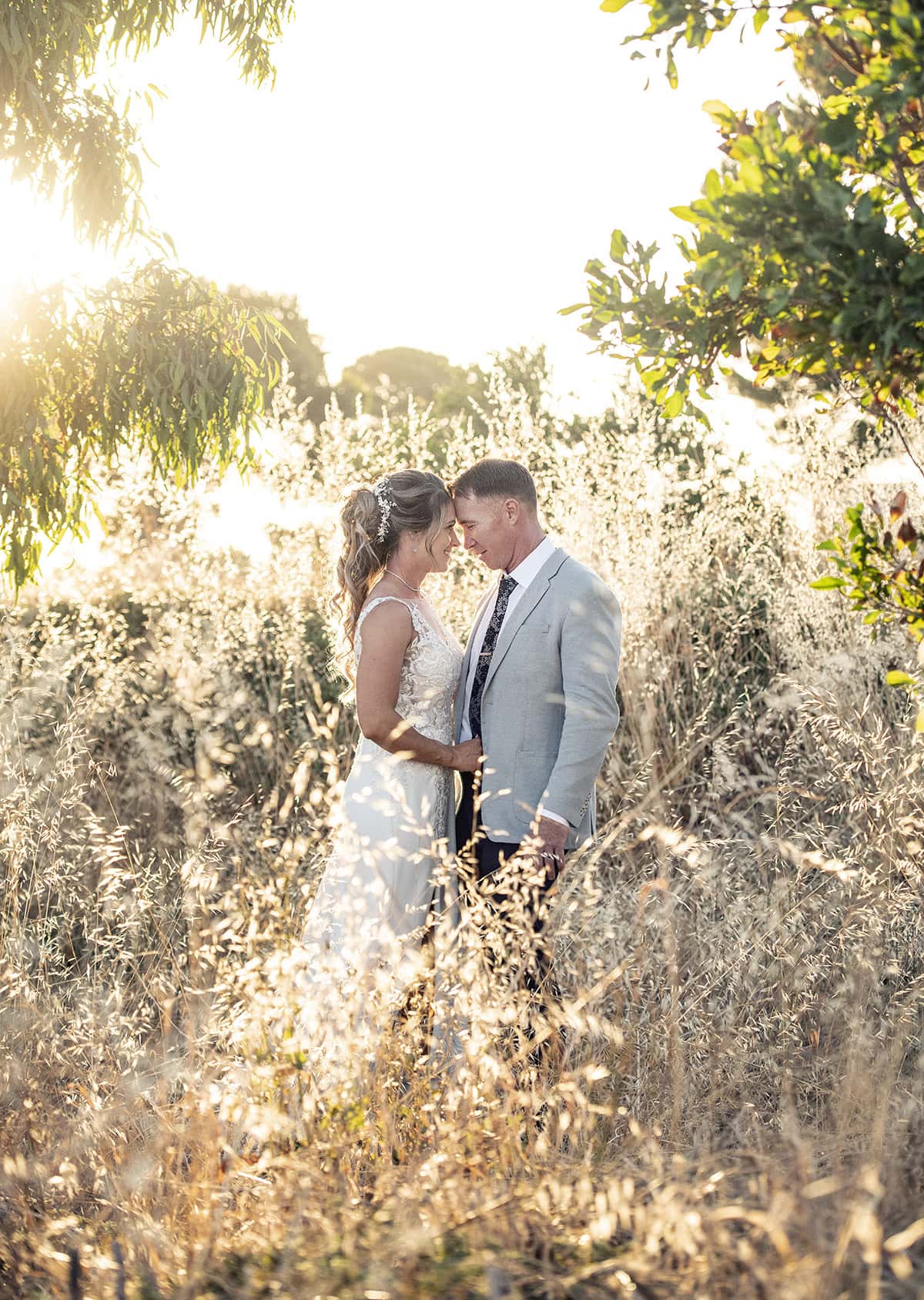 big easy radio wedding - leanne & evan 54 Bride and groom under the golden sun headbutting