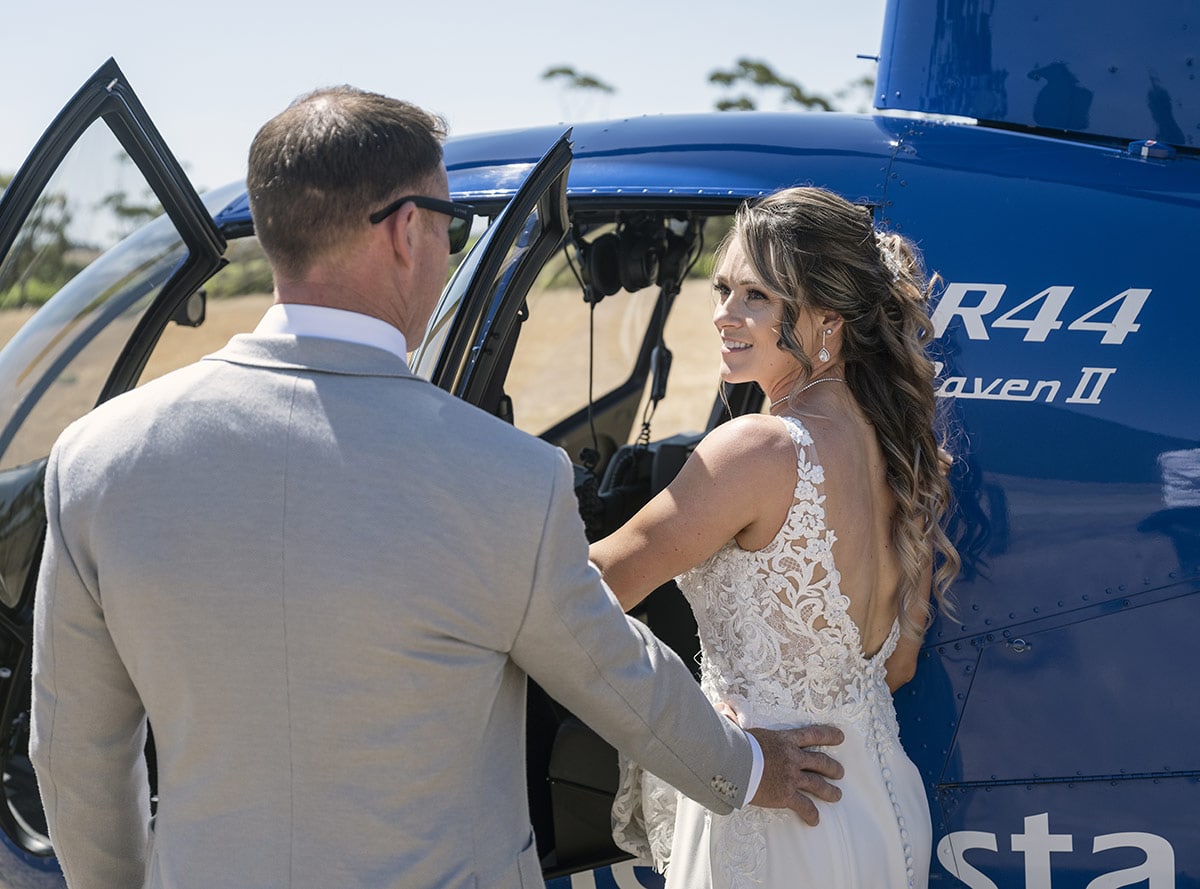 big easy radio wedding - leanne & evan 28 Bride looking back as she enteres helicopter