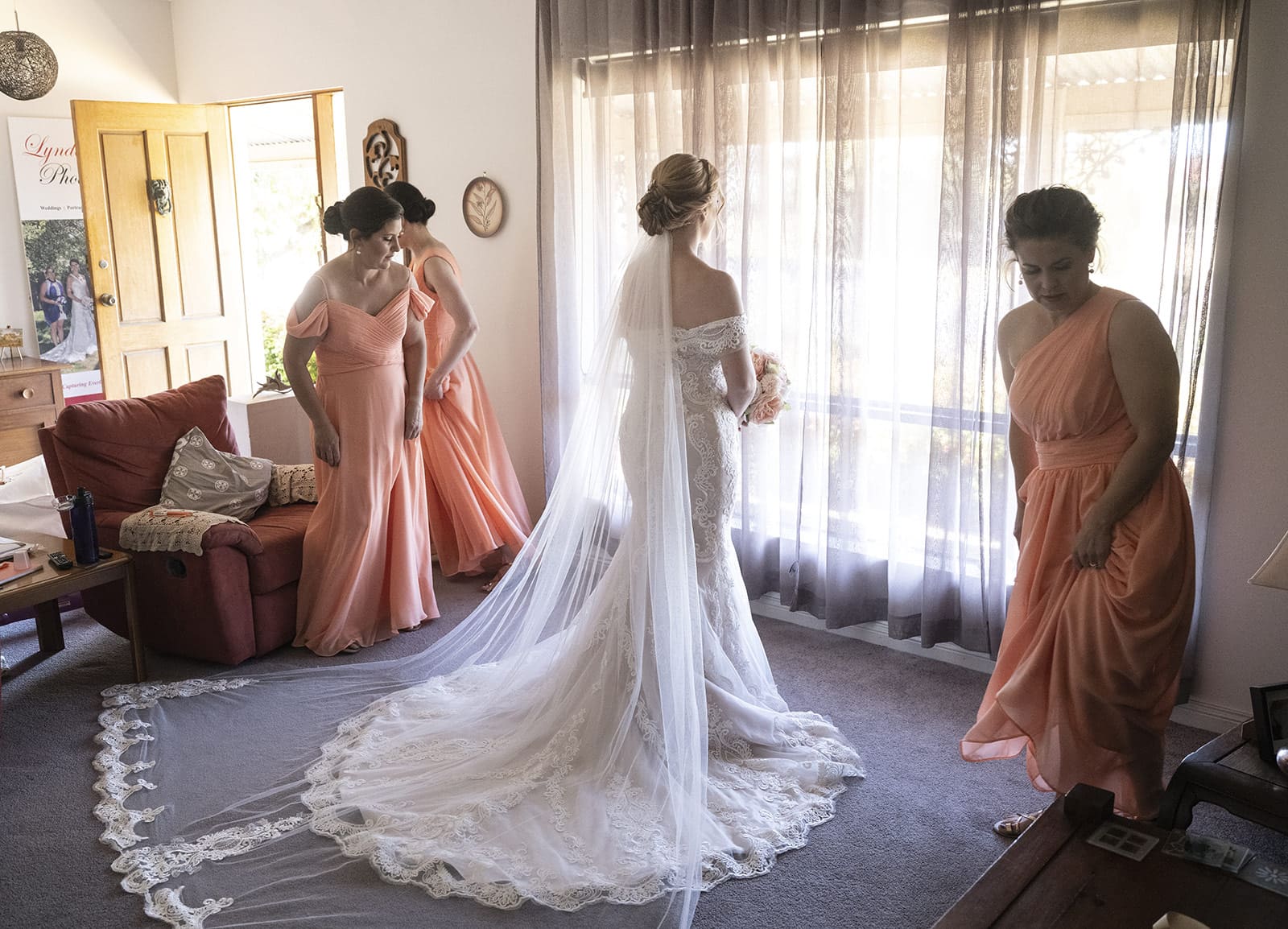 coriole wines wedding - marielle & brendan 15 Bride looking out window as bridesmaids watch