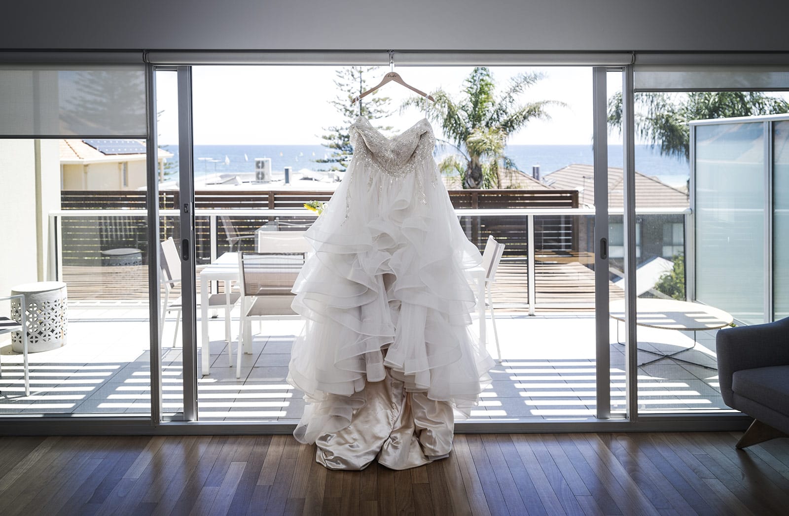lake breeze wines wedding - cate & renato 9 Wedding dress hanging with beach behind
