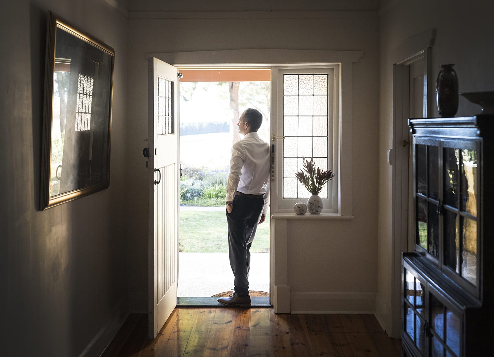 coriole wines wedding - marielle & brendan 6 Groom leaning on doorframe