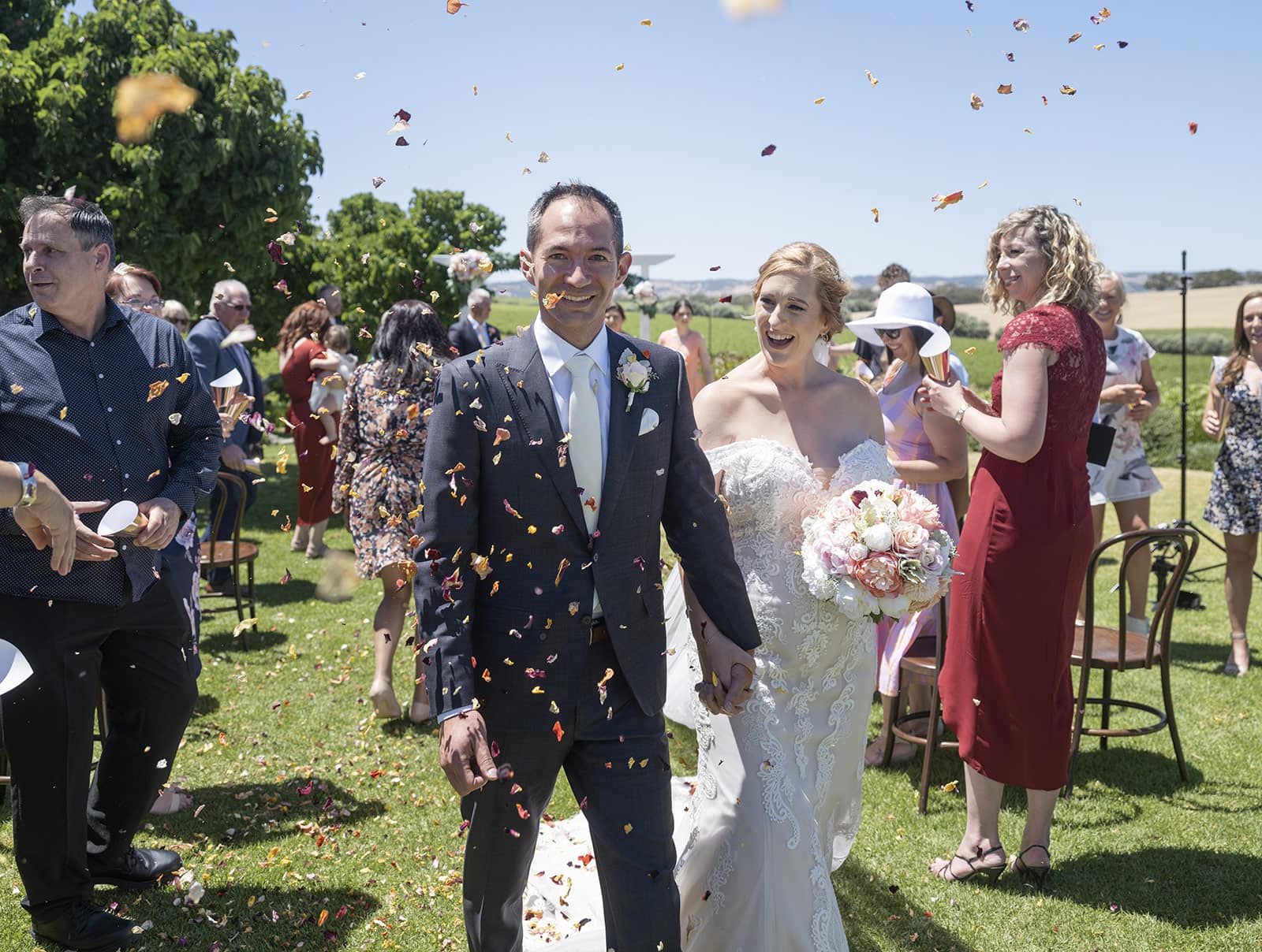 coriole wines wedding - marielle & brendan 48 Groom looking at camera under flower petals