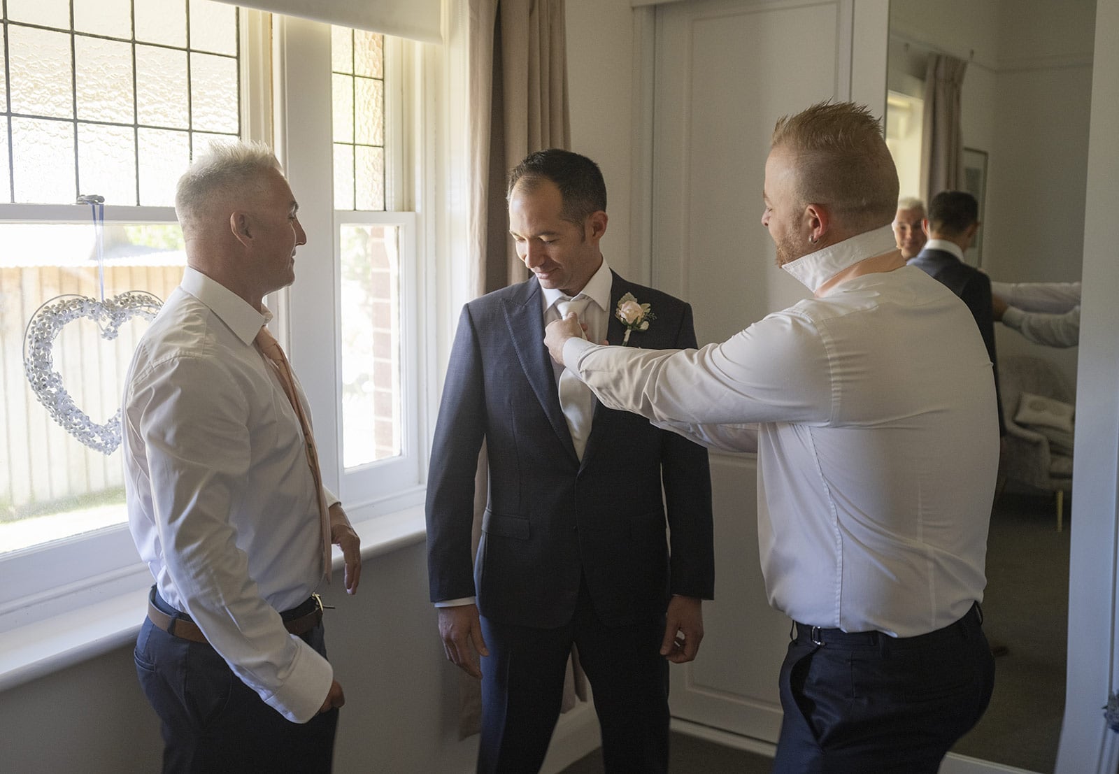 coriole wines wedding - marielle & brendan 8 groomsmen helping out with tie